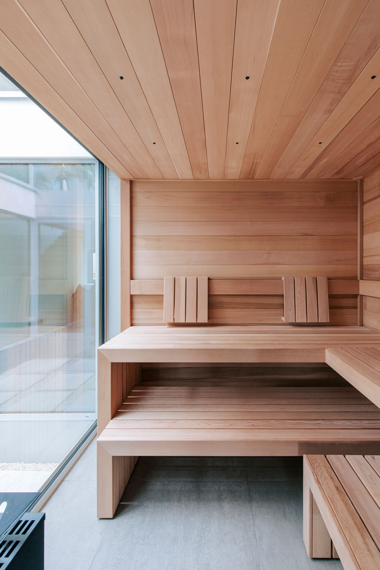 Sauna-Interior aus kanadischem Zedernholz ohne Maserung mit versetzbarem Hocker.